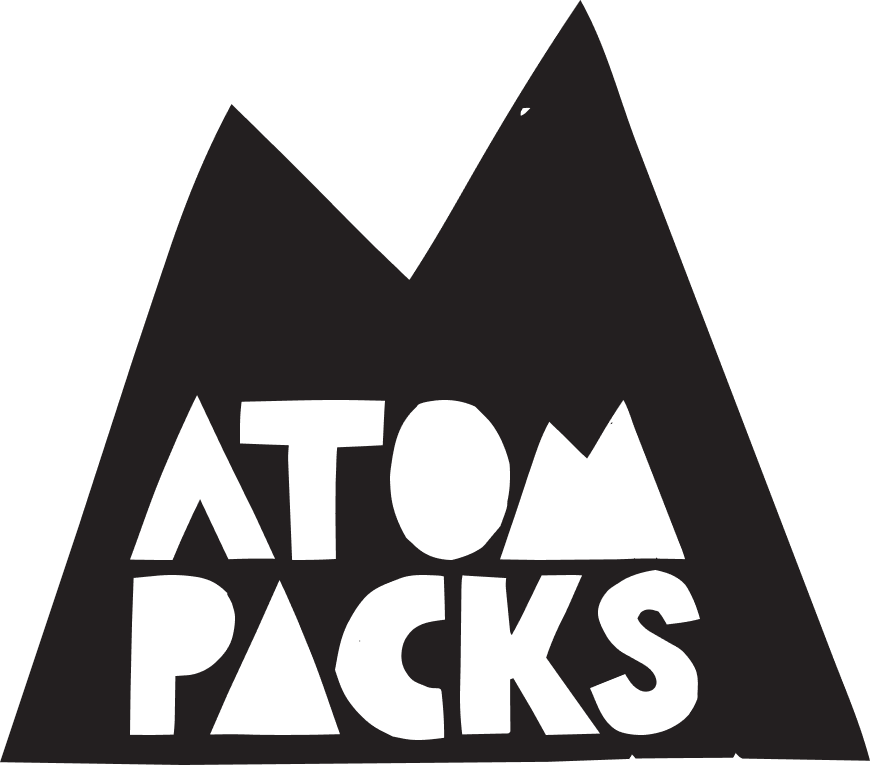 A black mountain-shaped graphic with the words 'ATOM PACKS' in bold white letters, shown on a plain white background.